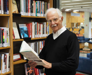 senior-reading-in-library