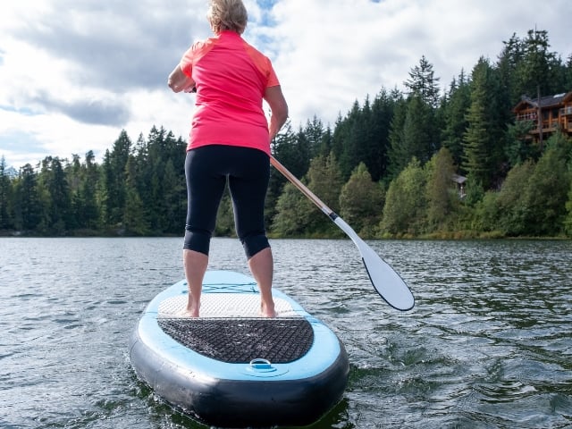 older woman on paddle board