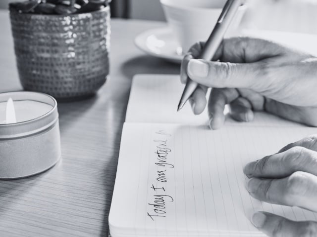 Person writing in journal 