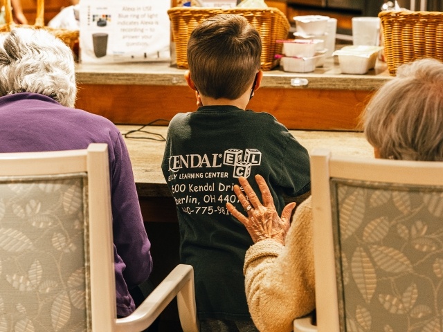 woman  sitting with hand on back of child