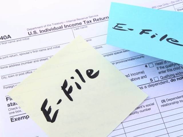 tax forms and yellow and blue post it notes with text E File 