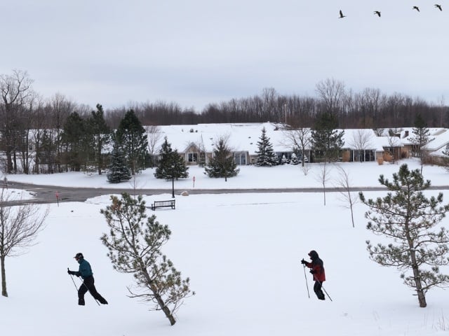 Two people walking in the snow