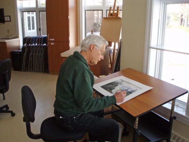 man sitting and drawing
