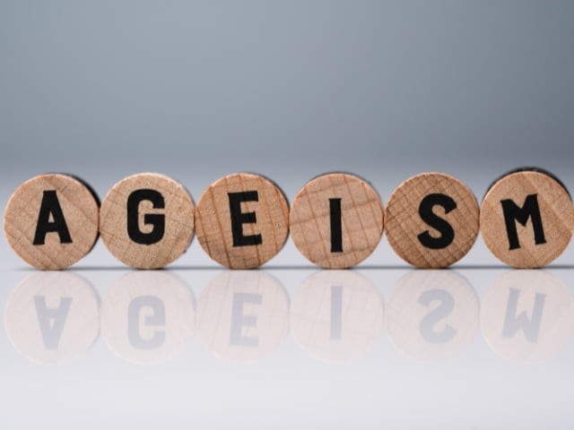 Ageism text on round wooden blocks 