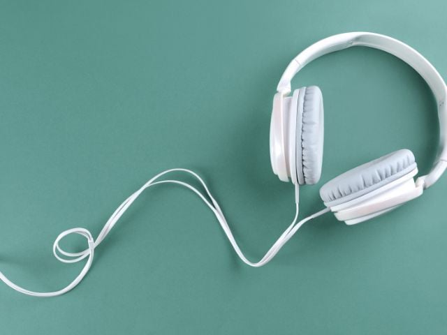 white headphones with green background