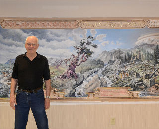 Man standing in front of his scenic painting