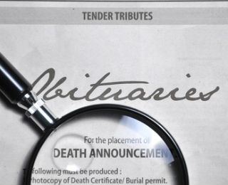 A paper with the word obituaries written on it