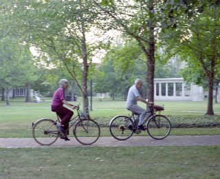 Man and woman riding bikes in the park