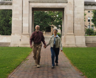 older couple walking and holding hands