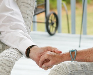 senior couple holding hands