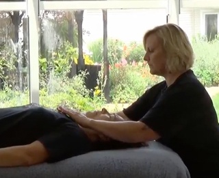 woman giving senior woman a massage