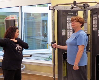 woman using a weight machine