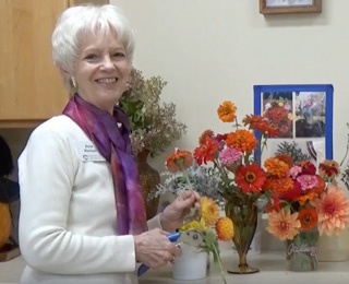 woman putting flowers in a vase