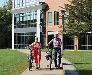 older adult couple riding bikes