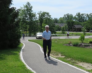 resident walking on Kendal campus