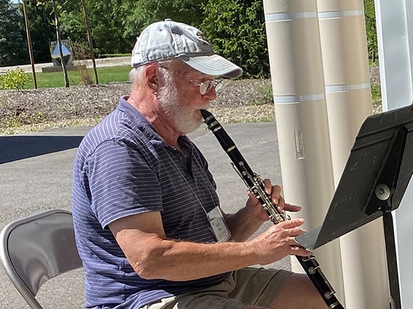 man playing clarinet outside