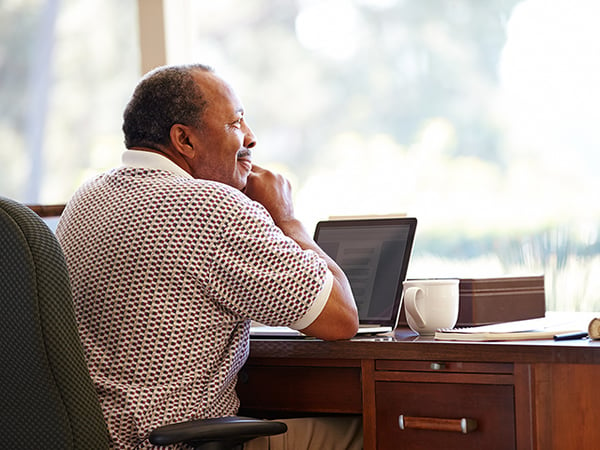 African-American older man with computer 