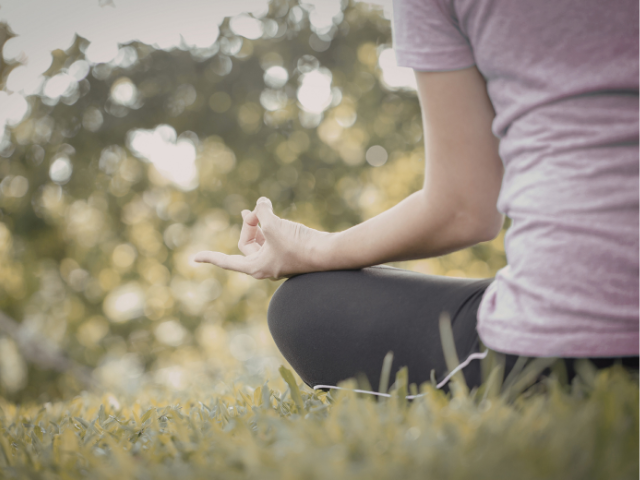 Person meditating outdoors