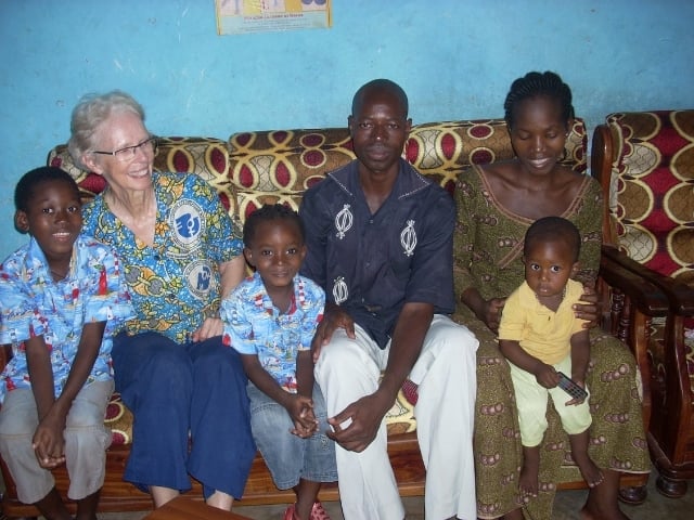 Jan (second from left) on sofa with a family