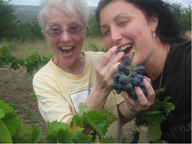 Barbara (on left) feeding grapes to friend 