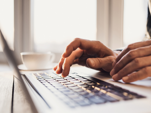 hands typing on computer 