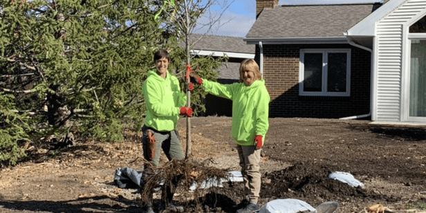 Rachel and Judy planting a tree 