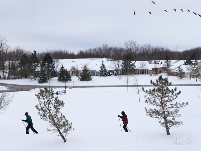 two people ski walking in the snow