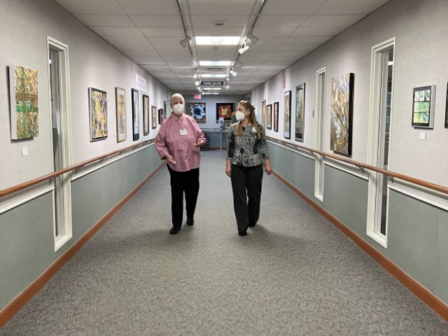 Barb Davis walking with staff