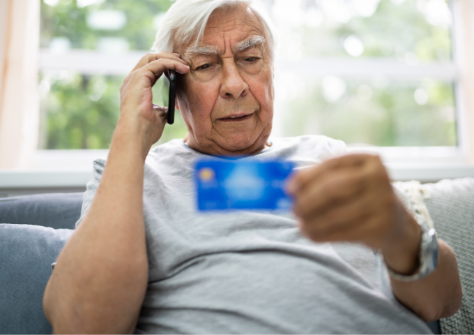 man holding phone and credit card 