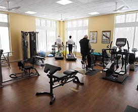 Residents using equipment at the community wellness center.