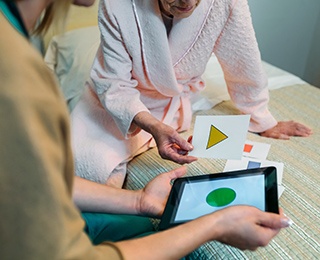 caregiver playing a brain game with older adult