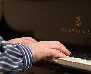 Kendal at Oberlin resident playing piano 