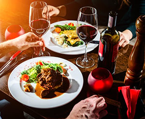 A couple sharing a bottle of wine during a romantic dinner