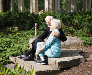 aging-couple-sitting-by-pond
